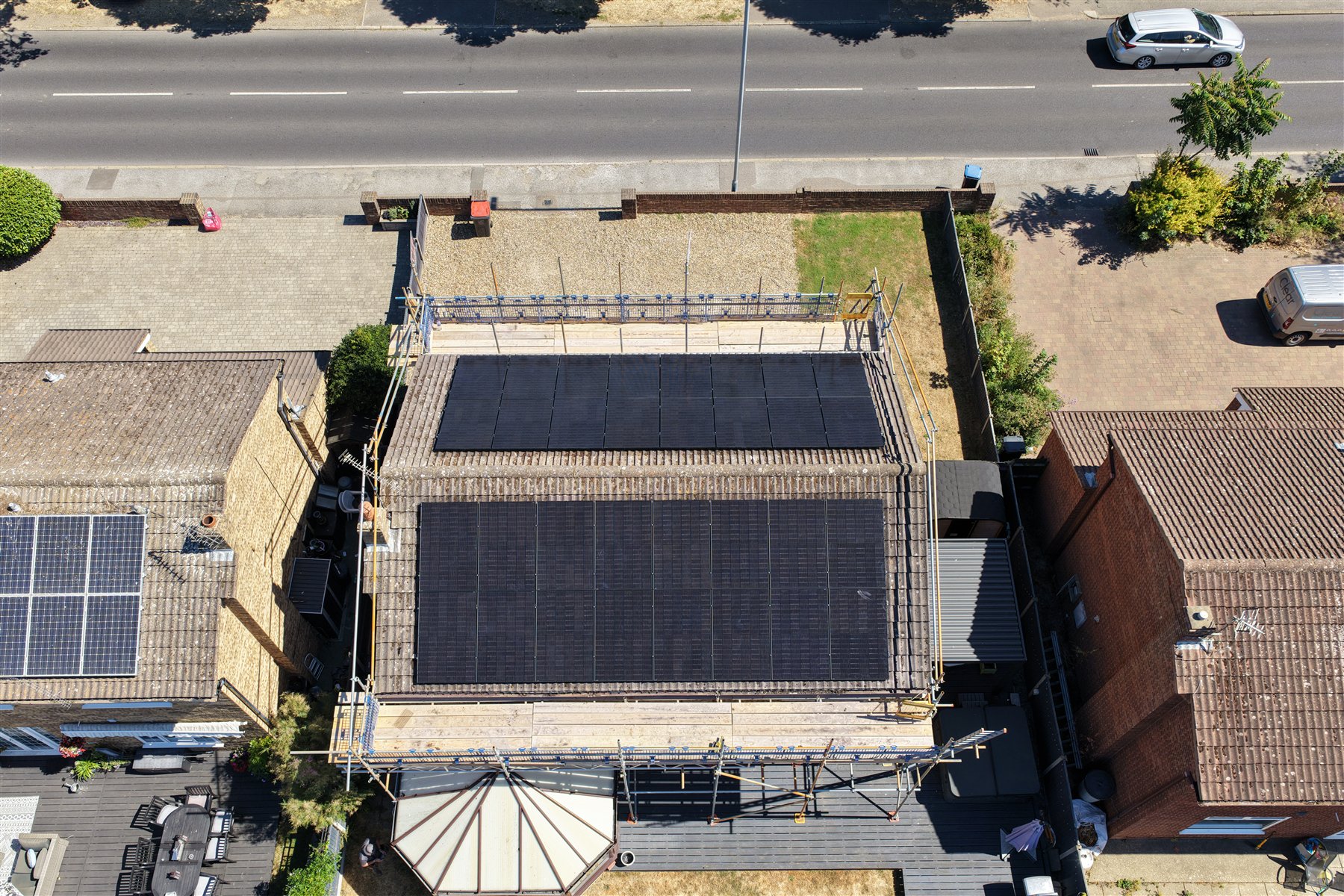 Top-down drone view of two solar arrays on a residential roof