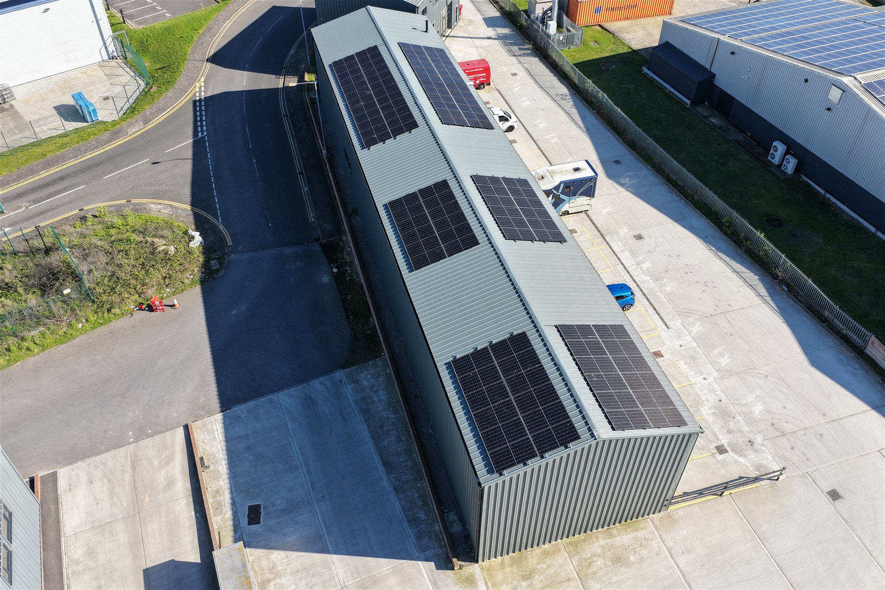Overhead drone view of multiple solar arrays on a commercial building