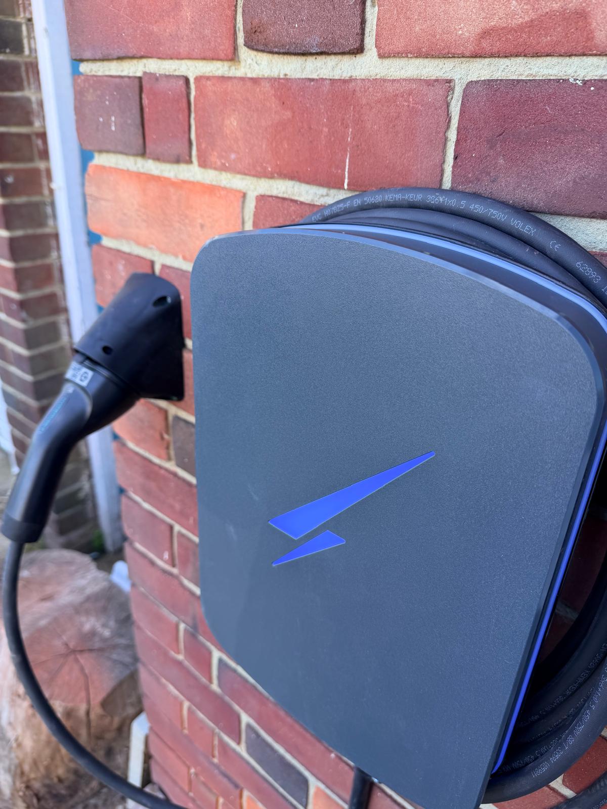 Close view of a smart electric vehicle charger installed by WH Renewables